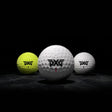 Three golf balls with PXG logo on a dark background