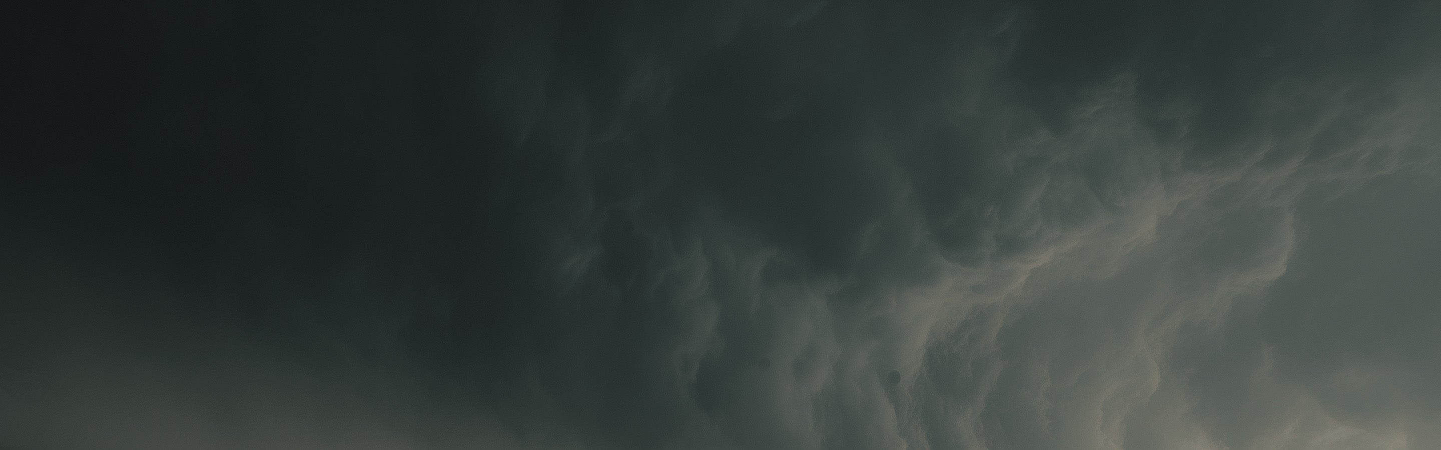 Dark, stormy sky with swirling clouds