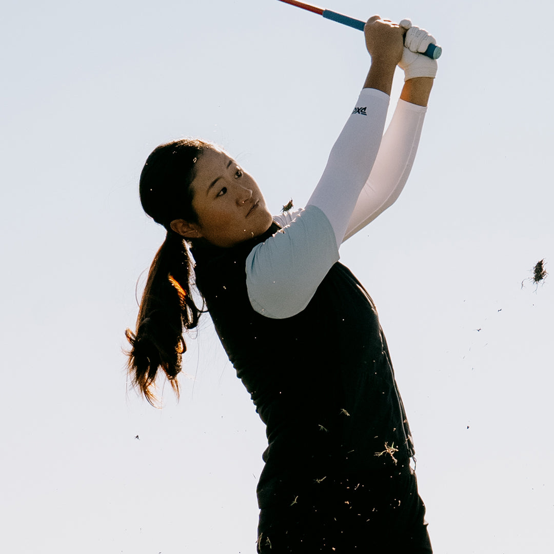 LPGA Tour Pro Gina Kim swinging against a white sky.