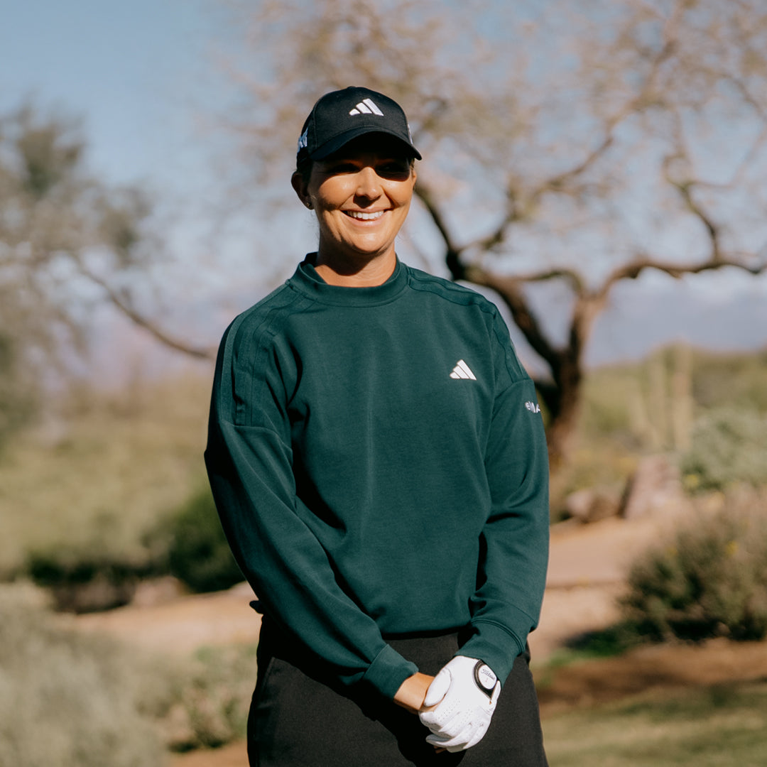 LPGA Tour Pro Linnea Strom smiling on a golf course.
