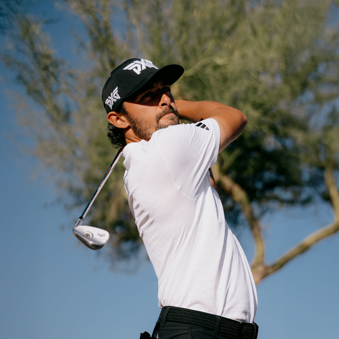 Marco Penge with a pxg hat swinging a golf club.