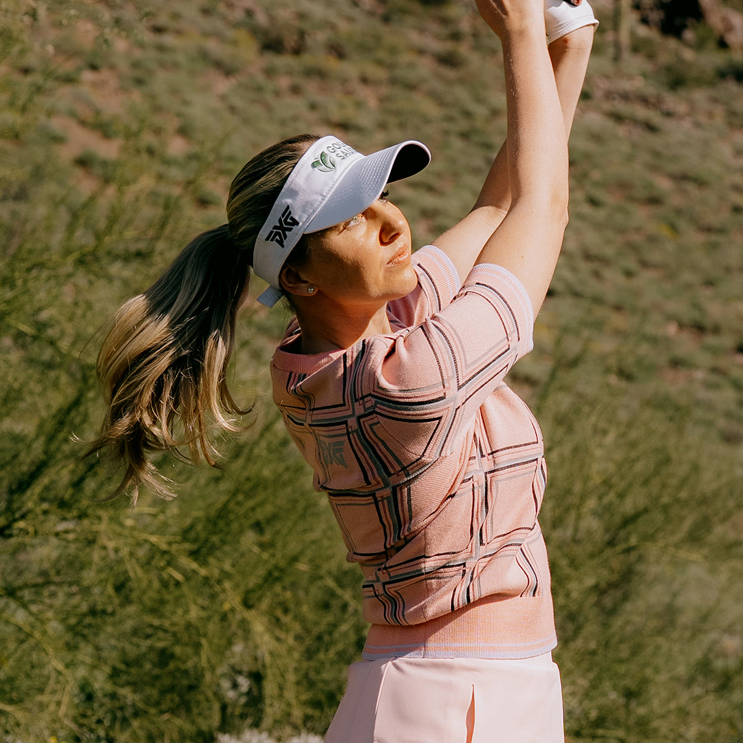 LPGA Tour Golfer Olivia Cowan swinging a golf club on a golf course.