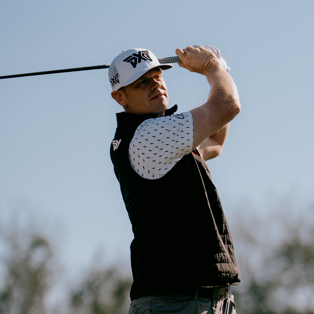 PGA Tour Pro Patrick Fishburn wearing a PXG Golf Hat on a golf course.