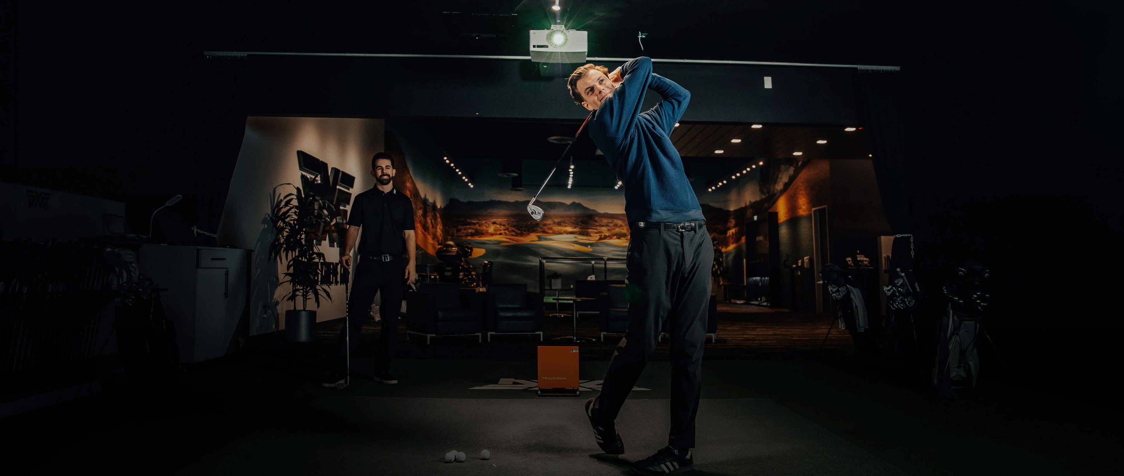 man swinging a golf club in a pxg golf club fitting