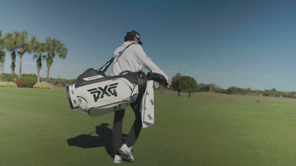 Marco Penge walking on a golf course with his pxg golf bag.